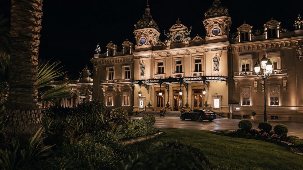 The Casino de Monte-Carlo facade at night seen from the garden side, belle epoque stonework lit from below